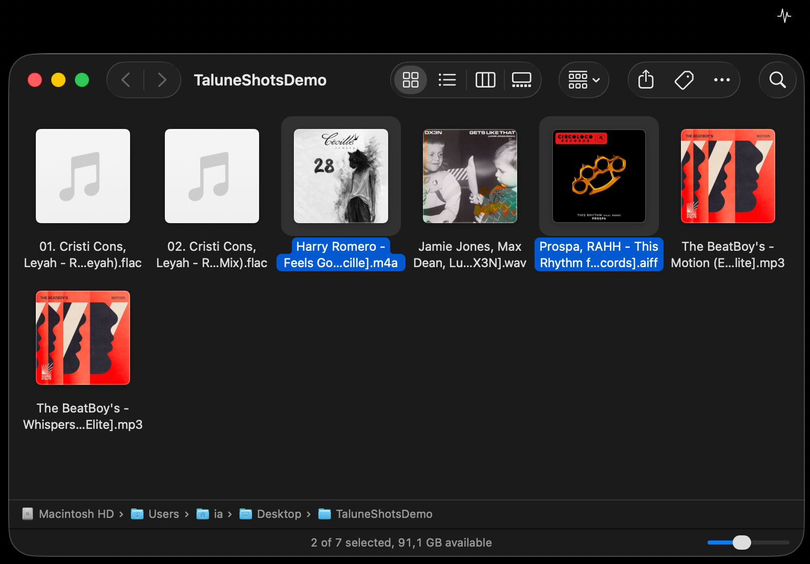 Finder window with two audio files selected in a folder of seven tracks.